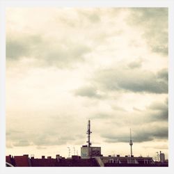 Low angle view of tower against cloudy sky