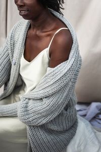 Midsection of woman with arms raised