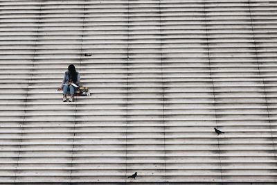 Full length of woman standing by railing