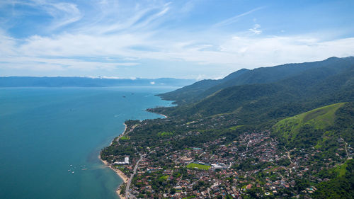 High angle view of townscape by sea against sky