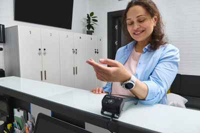 Portrait of young woman using mobile phone