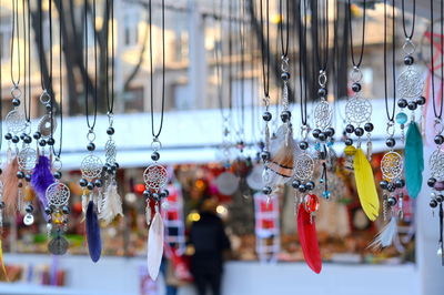 Close-up of decorations hanging in store for sale