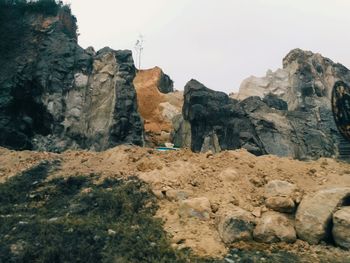 Rock formations on landscape against sky