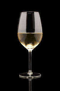 Close-up of wineglass against black background