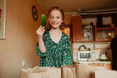 Portrait of smiling girl standing at home