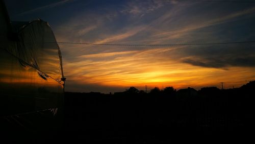 Silhouette landscape against sky during sunset