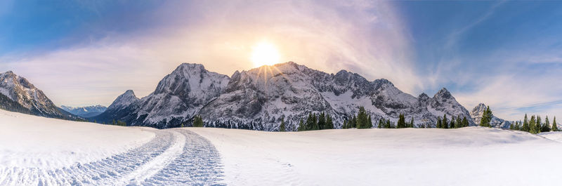 Scenic view of snow covered mountains against sky