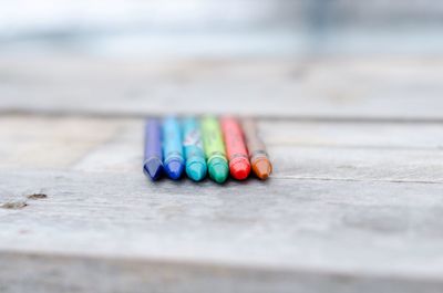 Close-up of multi colored crayons on wood
