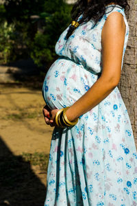 Midsection of woman standing outdoors