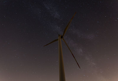 Low angle view of wind turbine at night