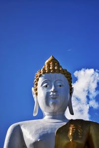 Low angle view of statue against blue sky