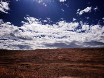 Scenic view of landscape against cloudy sky