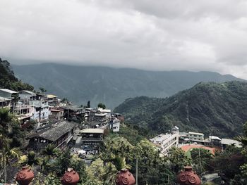 High angle view of townscape and mountains against sky