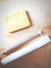 High angle view of hand holding bread on cutting board