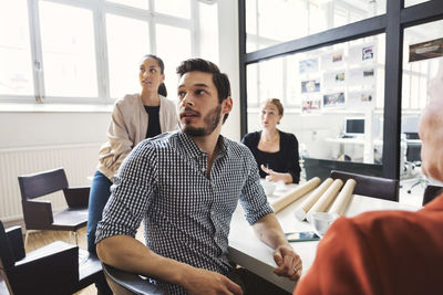 Multi-ethnic business people listening to presentation during meeting