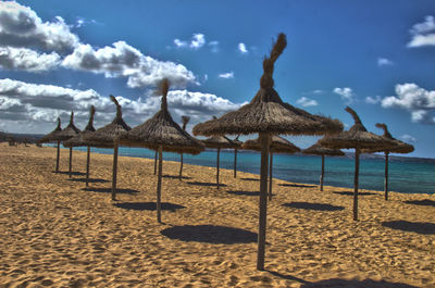 View of thatched roof beach umbrella