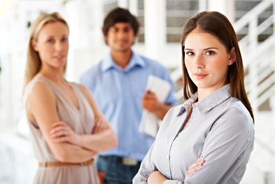 Portrait of smiling female friends standing in office