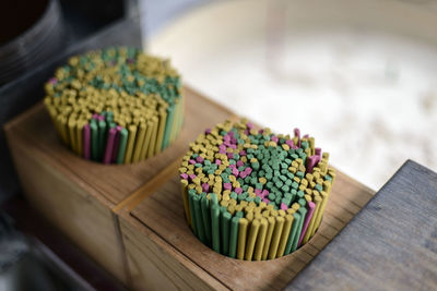 Close-up of incense sticks in container