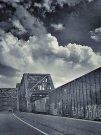 Empty road against cloudy sky