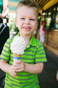 Portrait of smiling cute boy holding ice cream