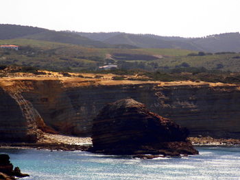 Scenic view of sea and rocks against sky