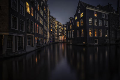 Reflection of buildings in water at night