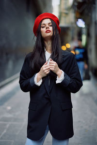 Portrait of young woman standing outdoors