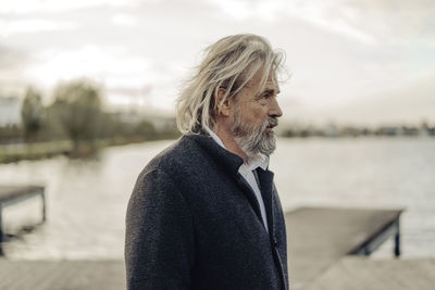 Portrait of serious senior man at a lake