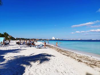 Scenic view of beach against blue sky