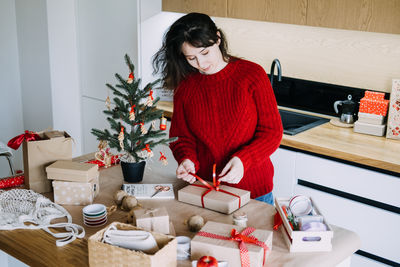 Portrait of young woman standing at home