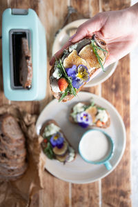 Delicious bruschetta with homemade bread, garnished with fig,soft cheese,pansies