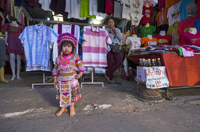 Full length of girl at market stall