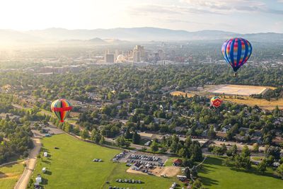 Hot air balloons flying over landscape