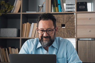 Man using laptop while sitting at home