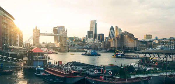 Boats in river with city in background