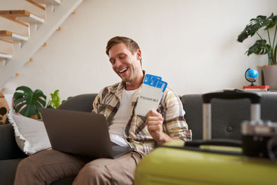 Young man using laptop while sitting at home
