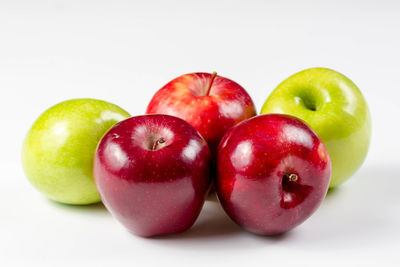 Close-up of apples in plate against white background