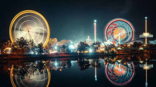 Night time view of spinning ferris wheel at volksfest, cannstatter wasen, stuttgart, germany