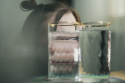 Close-up of woman in jar on table