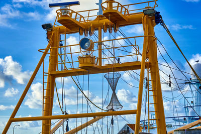 Steel yellow painted superstructures and masts of a trawler for catching fish, mussels and crabs