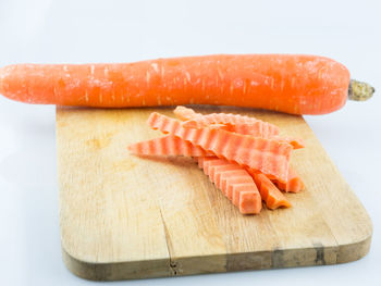 Close-up of fish on cutting board against white background