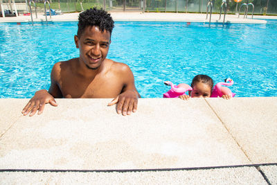 Portrait of young woman swimming in pool