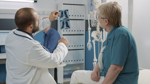 Side view of doctor examining patient at clinic