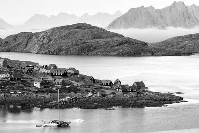 Houses on rocky hill in sea