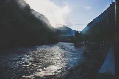 View of river with mountain range in background