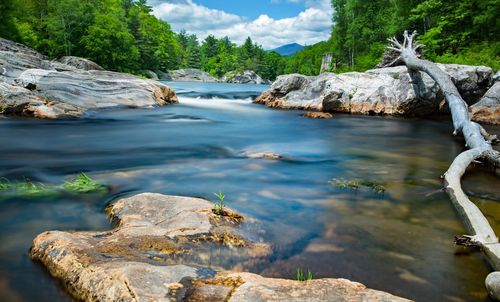 Scenic view of waterfall against sky