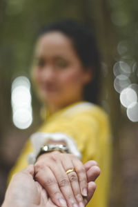 Close-up portrait of a woman holding hands