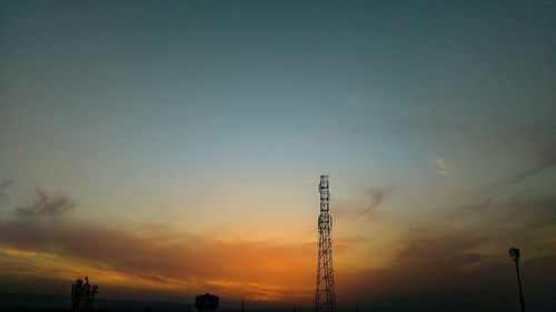 Low angle view of crane against sky during sunset