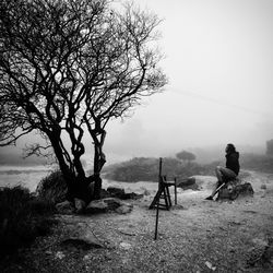 People sitting on landscape against sky