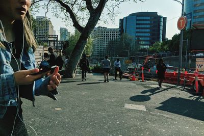 Group of people on road against buildings